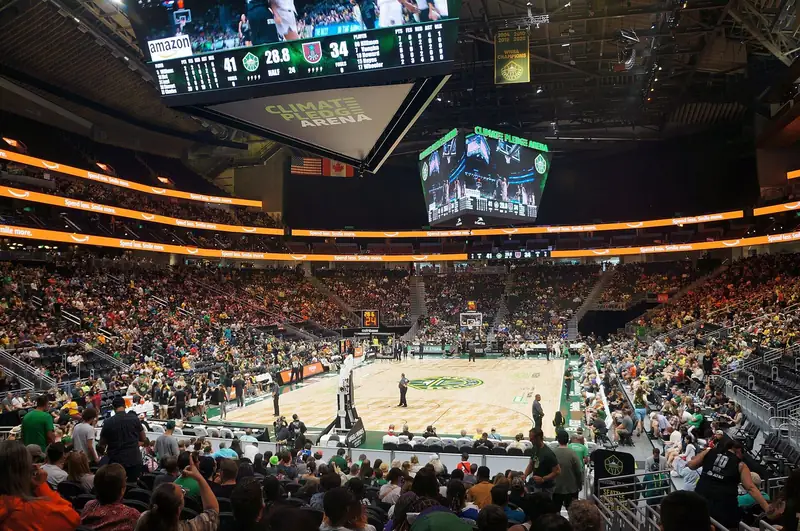 Climate Pledge Arena in Seattle seen from the upper deck during a Storm game, the court lit under the scoreboard.